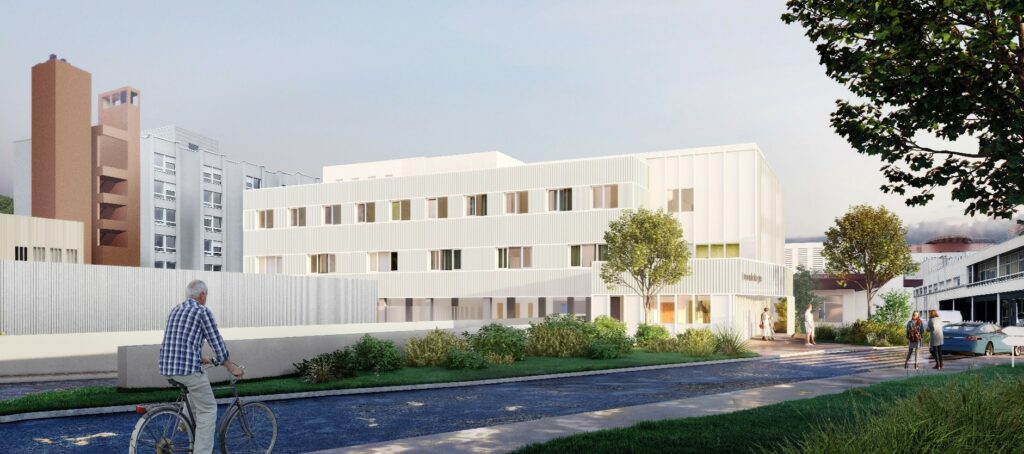 Bâtiment contemporain aux façades claires, intégré dans un environnement urbain paysager avec espaces verts et cheminements doux.Bâtiment odontologie Amiens